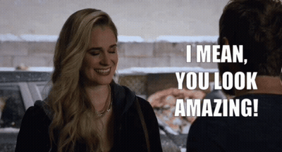 A Woman Is Smiling And Talking To A Man Who Says I Mean You Look Amazing GIF