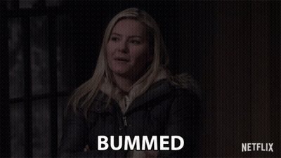 A Woman Is Smiling And The Word Bummed Is On The Screen Behind Her GIF
