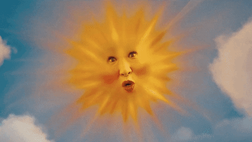 A Woman Is Smiling In A Field Of Flowers With Smiley Clouds In The Background GIF