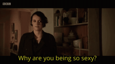A Woman Is Smiling In Front Of A Bookshelf And The Words Why Are You Being So Sexy GIF