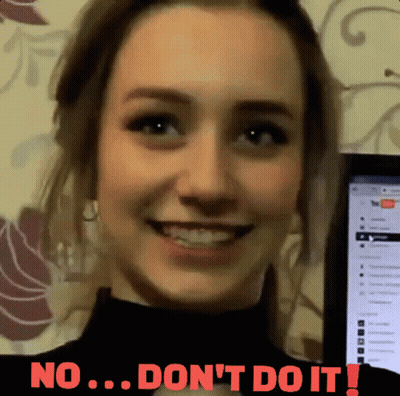 A Woman Is Smiling In Front Of A Computer Screen That Says No ... Don 'T Do It ! GIF