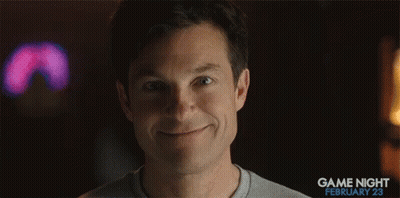 A Woman Is Smiling In Front Of A Game Night February 23 Ad GIF