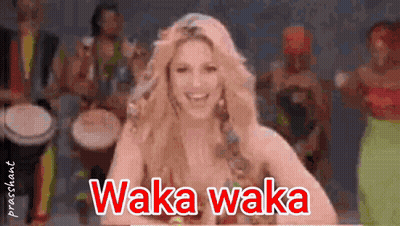 A Woman Is Smiling In Front Of A Group Of Drummers And The Words Waka Waka Are On The Screen GIF
