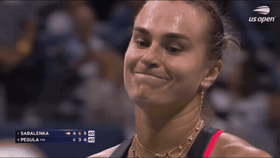 A Woman Is Smiling In Front Of A Scoreboard That Says Sabalenka On It GIF