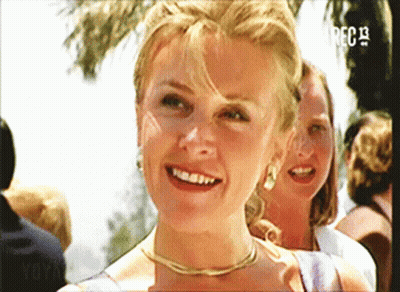 A Woman Is Smiling In Front Of A Screen That Says ' Rec 13 ' GIF