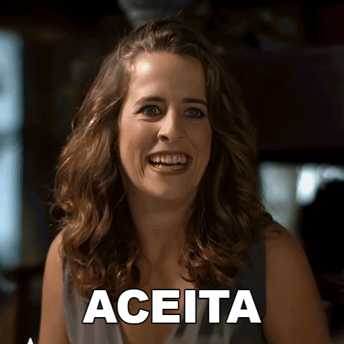 A Woman Is Smiling In Front Of A Sign That Says Aceita On It GIF