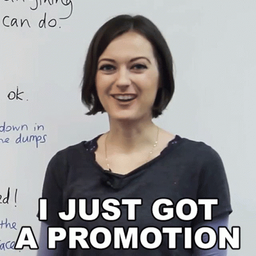 A Woman Is Smiling In Front Of A White Board That Says I Just Got A Promotion GIF