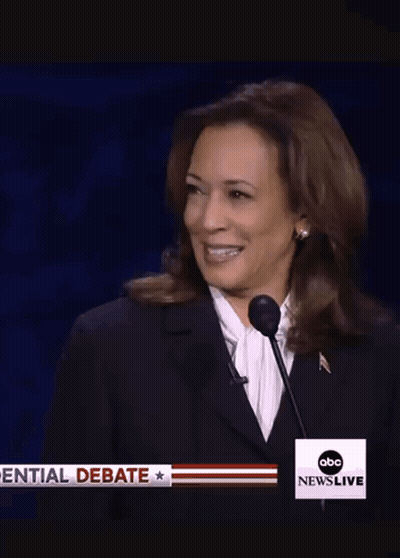 A Woman Is Smiling In Front Of An Abc News Live Advertisement GIF