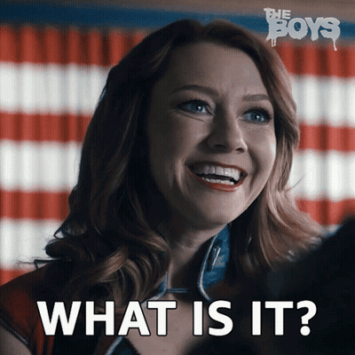 A Woman Is Smiling In Front Of An American Flag And Says What Is It GIF