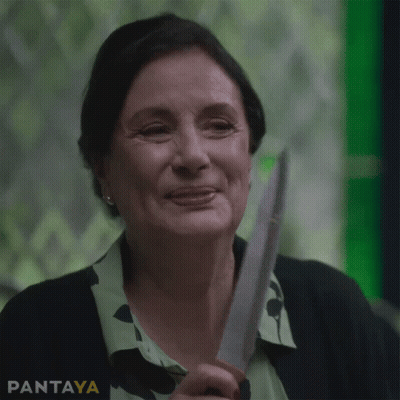 A Woman Is Smiling While Holding A Knife In Front Of A Green Background That Says Pantaya On It GIF