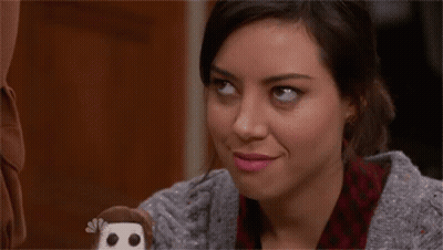 A Woman Is Smiling While Holding A Stuffed Monkey With The Letter B On It GIF