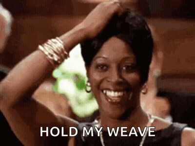 A Woman Is Smiling While Holding Her Hair In Her Hand And Says `` Hold My Weave '' . GIF
