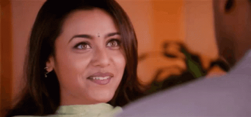 A Woman Is Smiling While Looking At A Man . GIF