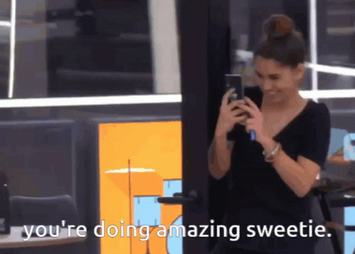A Woman Is Smiling While Looking At Her Phone And The Words You 'Re Doing Amazing Sweetie Are Next To Her GIF