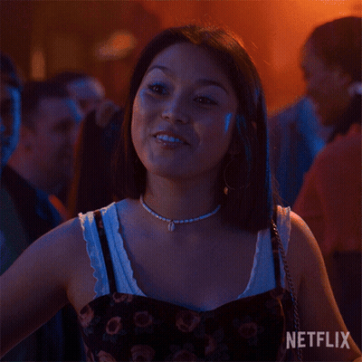 A Woman Is Smiling With A Netflix Logo In The Background GIF