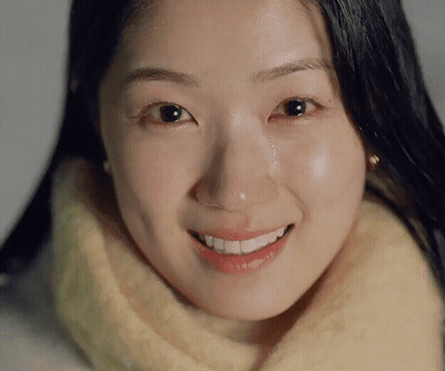 A Woman Is Smiling With A Tear Running Down Her Cheek GIF