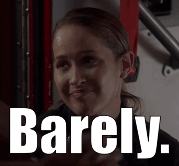 A Woman Is Smiling With Barely Written On Her Face GIF
