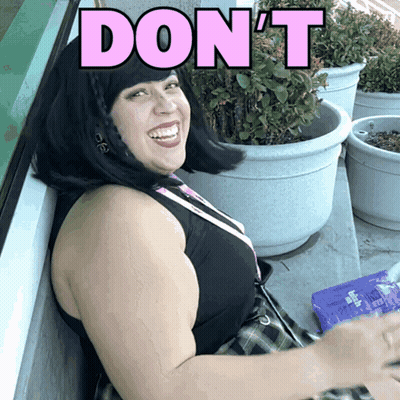 A Woman Is Smiling With The Word Don 'T In Pink Letters GIF