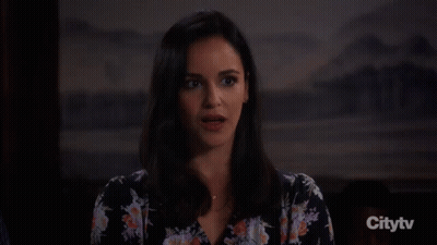 A Woman Is Smiling With The Word No Behind Her GIF