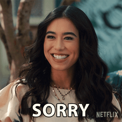 A Woman Is Smiling With The Word Sorry Written On Her Face GIF