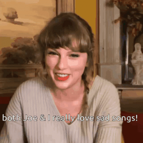 A Woman Is Smiling With The Words Both Joe And I Really Love Sad Songs Below Her GIF