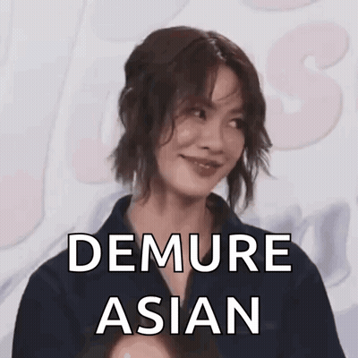 A Woman Is Smiling With The Words `` Demure Asian '' Written Above Her . GIF