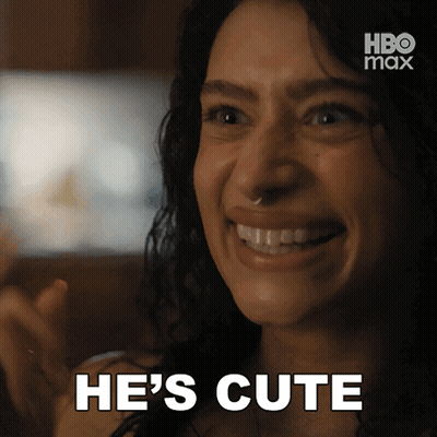 A Woman Is Smiling With The Words He 'S Cute Written Below Her GIF