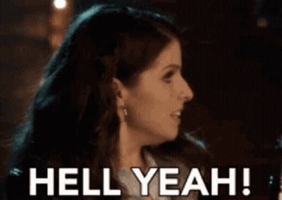 A Woman Is Smiling With The Words Hell Yeah Behind Her GIF