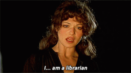 A Woman Is Smiling With The Words " I Am A Librarian " Next To Her GIF