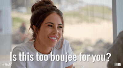 A Woman Is Smiling With The Words " Is This Too Boujee For You " GIF