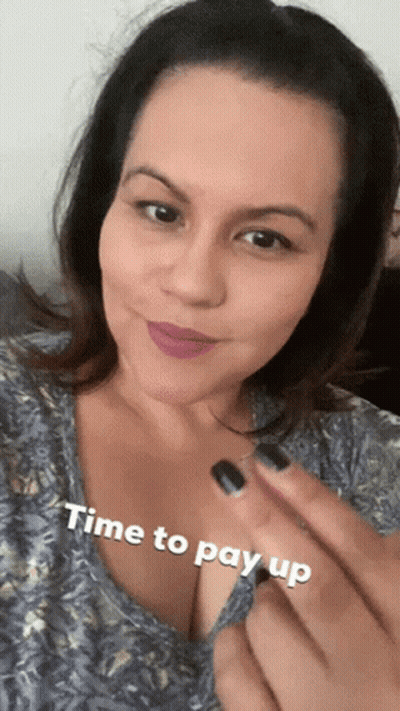 A Woman Is Smiling With The Words Time To Pay Up On Her Chest GIF