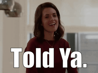 A Woman Is Smiling With The Words `` Told Ya '' Written Above Her . GIF