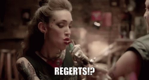 A Woman Is Smoking A Cigarette And Says Regerts GIF