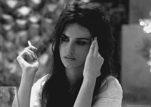 A Woman Is Smoking A Cigarette In A Black And White Photo With The Caption Imperial Bedrooms GIF