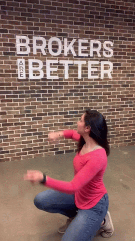 Woman Squatting In Front Of Brick Wall With Brokers Are Better GIF