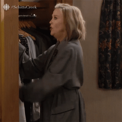 A Woman Is Standing In A Closet And Saying I 'M Building A Mystery GIF