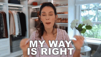 A Woman Is Standing In A Closet Holding A Flower And Saying My Way Is Right . GIF
