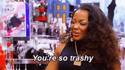 A Woman Is Standing In A Clothing Store And Talking To Someone . GIF
