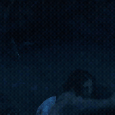 A Woman Is Standing In A Dark Room With Red Smoke Coming Out Of Her Eyes . GIF