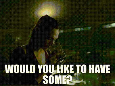 A Woman Is Standing In A Dark Room With The Words `` Would You Like To Have Some '' Written Above Her . GIF