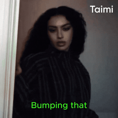 A Woman Is Standing In A Doorway With The Words Bumping That On The Bottom Right GIF