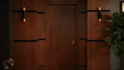 A Woman Is Standing In A Hallway With A Sign That Says Mst On It GIF