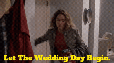 A Woman Is Standing In A Hallway With The Words Let The Wedding Day Begin On The Bottom GIF