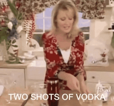 A Woman Is Standing In A Kitchen Preparing A Drink And Says `` Two Shots Of Vodka '' . GIF