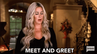 A Woman Is Standing In A Living Room And Says Meet And Greet Bravo . GIF