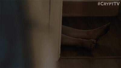A Woman Is Standing In A Room With A Blurred Background . GIF