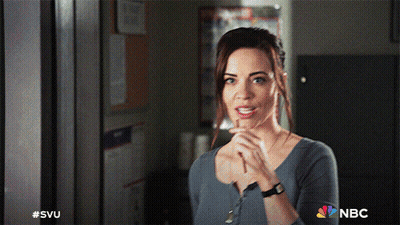 A Woman Is Standing In A Room With The Nbc Logo On The Bottom GIF