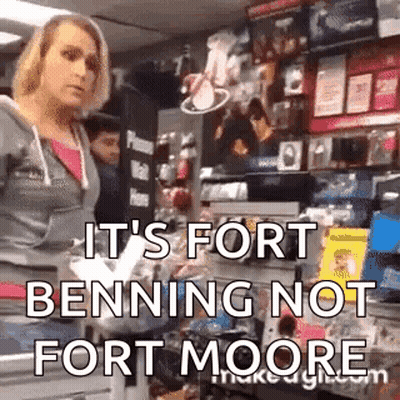 A Woman Is Standing In A Store With The Words `` It 'S Fort Benning Not Fort Moore '' Written On Her Face . GIF