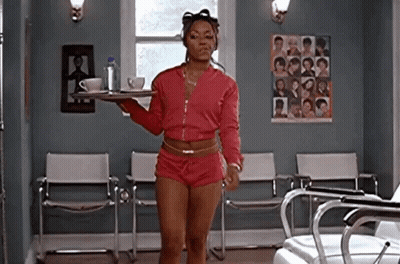 A Woman Is Standing In A Waiting Room Holding A Tray Of Coffee And Tea . GIF