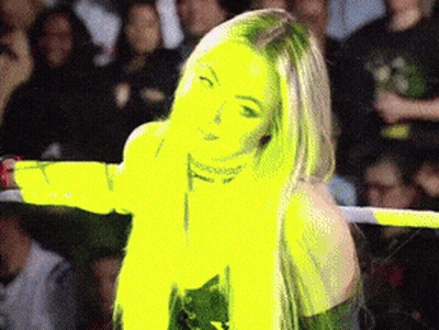 A Woman Is Standing In A Wrestling Ring With Her Arms Outstretched In Front Of A Crowd GIF